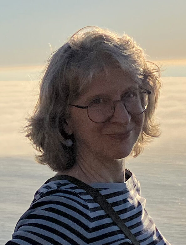 Profile of Patty A. Gray against Pacific Ocean at sunset.